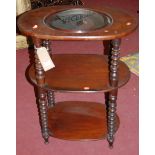 A Victorian mahogany oval three-tier wash stand, raised on bobbin turned supports (lacking ceramic