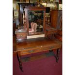 A late Victorian walnut bevelled swing mirrorback dressing table, having twin frieze drawers and