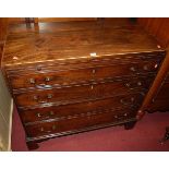 An early 19th century mahogany chest, of four long graduated drawers, having upper brushing slide