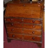 An early 19th century provincial oak slopefront writing bureau, having a fitted interior, over