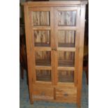 A contemporary light oak double door glazed display cabinet, having twin short lower drawers, w.97.