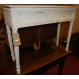 A contemporary white painted two drawer hall table, raised on turned supports, w.93.5cm