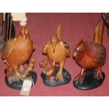 Three various contemporary African carved hardwood figures of cockerels, the largest h.46cm