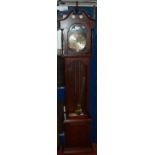 A contemporary Lincoln oak 31-day longcase clock, having an arched dial, glazed trunk door, twin