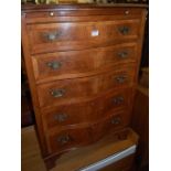 A circa 1900 figured walnut and crossbanded serpentine front chest, of five long graduated