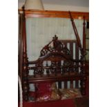 A late 19th century, possibly Colonial, floral carved oak double full tester bed, the headboard