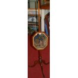 A Regency mahogany pole screen, having octagonal woolwork inset panel depicting a young girl