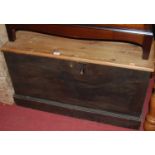 A stained pine plank topped hinged tool chest, having iron end carry handles, w.85cm
