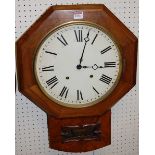 A mid-Victorian figured walnut octagonal droptrunk wall clock, having circular white enamel dial