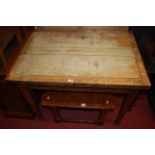 A 1930s faded oak fold-over dining table, having pull-out support, w.95.5cm