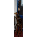 Two contemporary African carved hardwood models of standing giraffes, the largest h.155cm