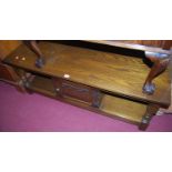 A contemporary Old Charm moulded oak two-tier low coffee table, having single central cupboard door,