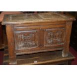 A small 17th century style joined oak twin panelled hinge topped coffer, w.76cm