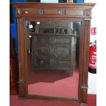 A circa 1900 French oak overmantel mirror, the frame having raised panels and twin fluted columns,