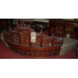 A circa 1900 carved and pierced walnut demi-lune four-poster bed pediment, having floral embroidered