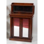 A late Regency rosewood chiffonier, the raised superstructure having a three-quarter gallery and