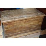 A rustic scrumble-finished pine hinge topped tool chest, having iron end carry handles, w.92.5cm