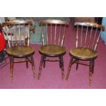 A set of three early 20th century fruitwood and beech stickback kitchen chairs
