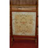 An Edwardian mahogany and floral silk needlework inset fire-screen, the panel 66 x 63.5cm