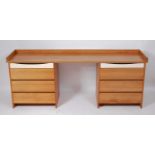 A contemporary cherry-wood long twin pedestal dressing table, each pedestal comprising three