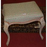 An early 20th century limed wood framed and upholstered padseat dressing stool, raised on floral