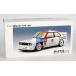 An Auto Art Millennium model No. 89146 1/18 scale model of a BMW E30 M3DTM 1991 race car finished in