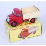 A Dinky Toys No.410 Bedford end tipper, comprising of red cab and chassis with cream back and red