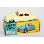 A Corgi Toys No. 208S Jaguar 2.4L saloon comprising of lemon yellow body with red interior and