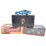 A 1/18 scale boxed diecast group to include a Kyosho 1/18 scale model of a Calsonic Skyline GTR,