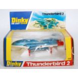 A Dinky Toys No. 106 Thunderbird 2 comprising of metallic blue body with white features and red