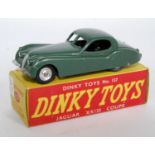 A Dinky Toys No. 157 Jaguar XK120 Coupe comprising of sage green body with spun hubs and silver