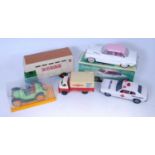 A collection of boxed and loose tinplate vehicles and accessories, to include a Korean ambulance