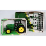 An ERTL boxed John Deere large scale tractor and implement group to include a John Deere 7600