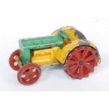 A Dinky Toys No.22E pre-war farm tractor, comprising of yellow and green body with red hubs (
