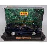 A Maisto 1/12 scale model of Jaguar XJ220 1992 race car finished in metallic dark blue, housed in