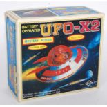 A Daiya of Japan tinplate plastic and battery operated model of a UFO-X2 spaceship comprising red