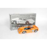 A GMP No. 12021 1/18 scale model of a Bruce Maclaren M8A race car comprising of orange body with