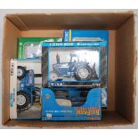 Five various boxed ERTL and Siku Ford diecast tractors to include an ERTL New Holland Ford 8630, a