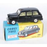 A Corgi Toys No.418 Austin Taxi, comprising of black body with lemon interior and spun hubs,