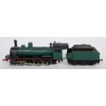 A metal H0 continental outline 0-8-0 engine and tender finished matt green/red railway company