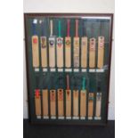 A large framed display of 18 County Cricket presentation bats,