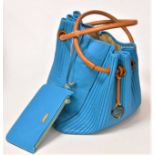 A ladies Georgio Armani blue leather hand bag with brown leather ring handles, together with a