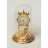 A 20th century German lacquered brass anniversary clock under dome, having enamelled dial with