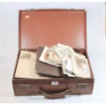 A small stitched leather suitcase and contents to include various postcards, greetings cards,