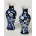 A pair of Chinese blue and white stoneware vases, each of baluster form, decorated with prunus, h.