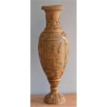 An Eastern European carved softwood vase, of baluster form, with carved crest and scrolling
