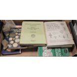 A box containing a collection of books related to numismatics, to include Collecting Coins by C.W.