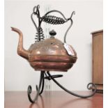 An Arts & Crafts copper kettle, of squat circular form, with raised sinuous floral decoration, on