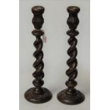 A pair of large 1920s carved oak barleytwist candlesticks, h.47cm