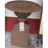 A cast iron circular pedestal garden urn on plinth, height 58cm, dia. 45cm